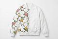 White unisex bomber jacket with pink and yellow roses and thorny green vines on the left side